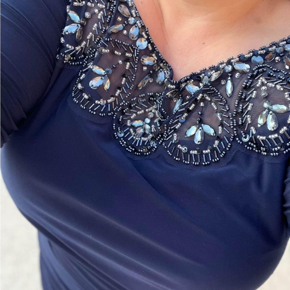 Beautiful beaded dress with a zipper in the back.  Heavy material.
